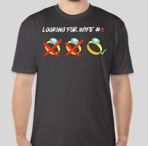 The Looking For t-shirt features three marital rings. Two of the three rings are x'd out. The t-shirt is comedic in nature. The raw BHS logo is applied to the back of the t-shirt.