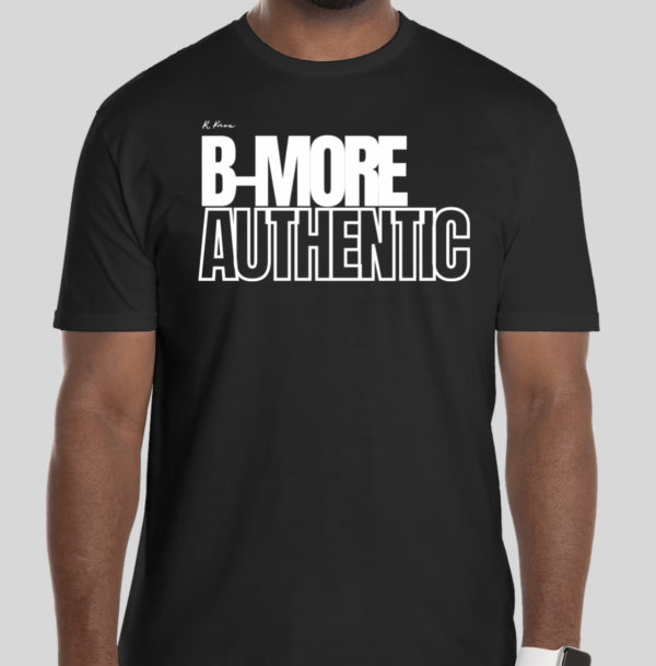 The B-More Authentic t-shirt features boxed text which spells out an abbreviated version of the word Baltimore. An altered version of the BHS logo is applied to the back of the t-shirt.