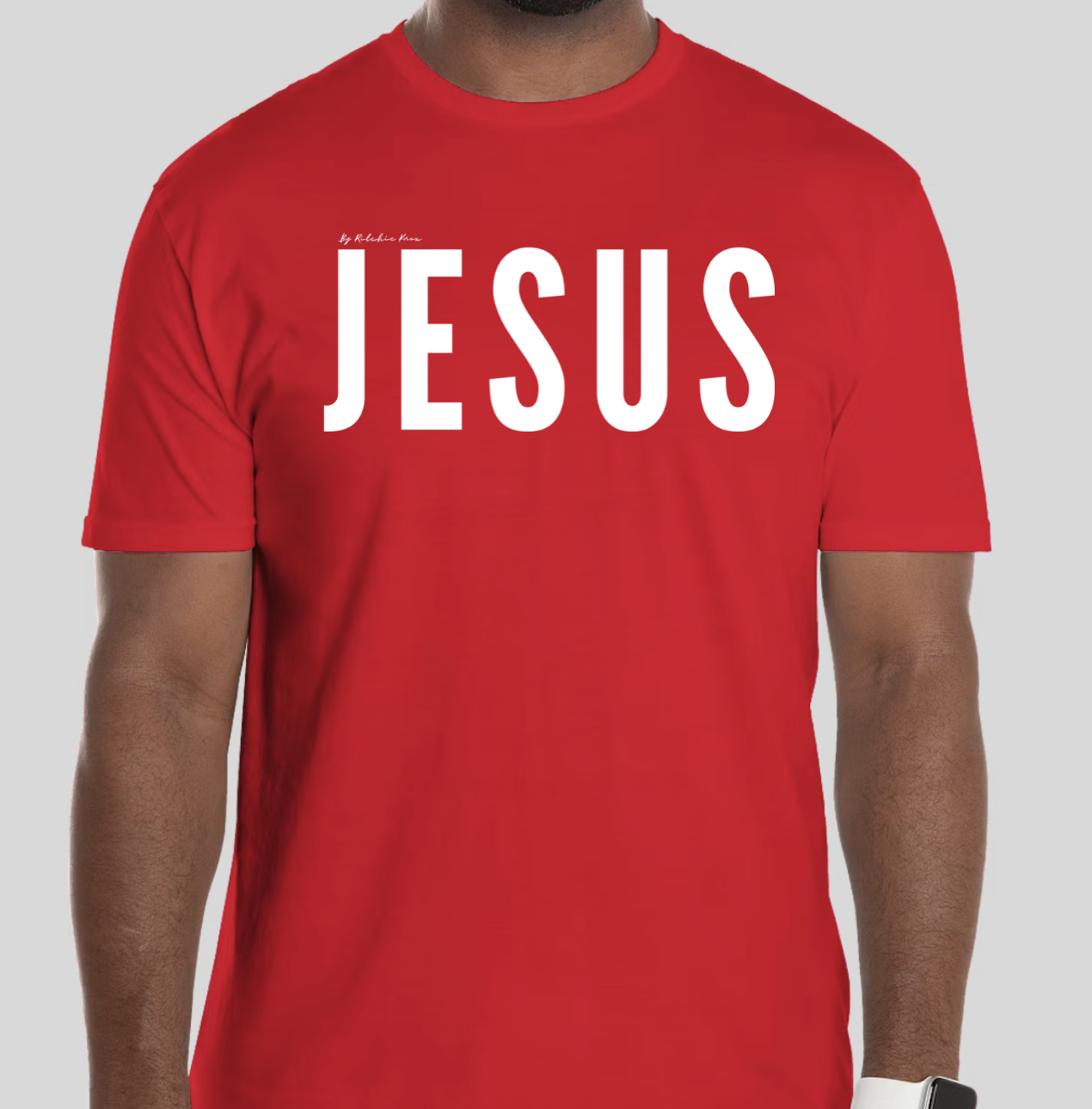 Red t-shirt with the word 'Jesus' in bold white letters on the front; back features Broken Heart Shirts logo with a 'B', broken heart icon, and 'S'.